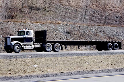 Flatbed semi truck - contact a qualified Lafayette Truck Accident Lawyer if you are involved in an accident with a flatbed truck.